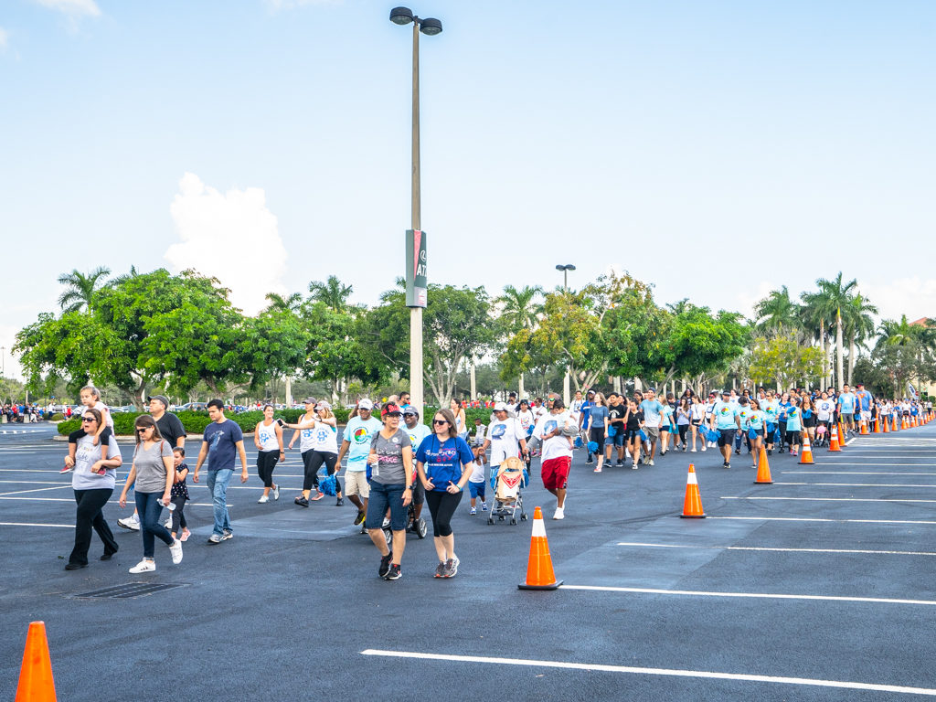 Petland Florida team walking in parking lot at Autism Speaks Walk.
