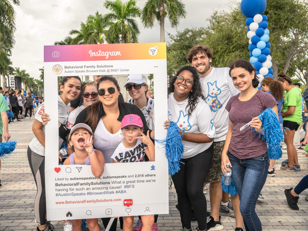 Petland team members posing with Instagram sign at Autism Speaks walk.