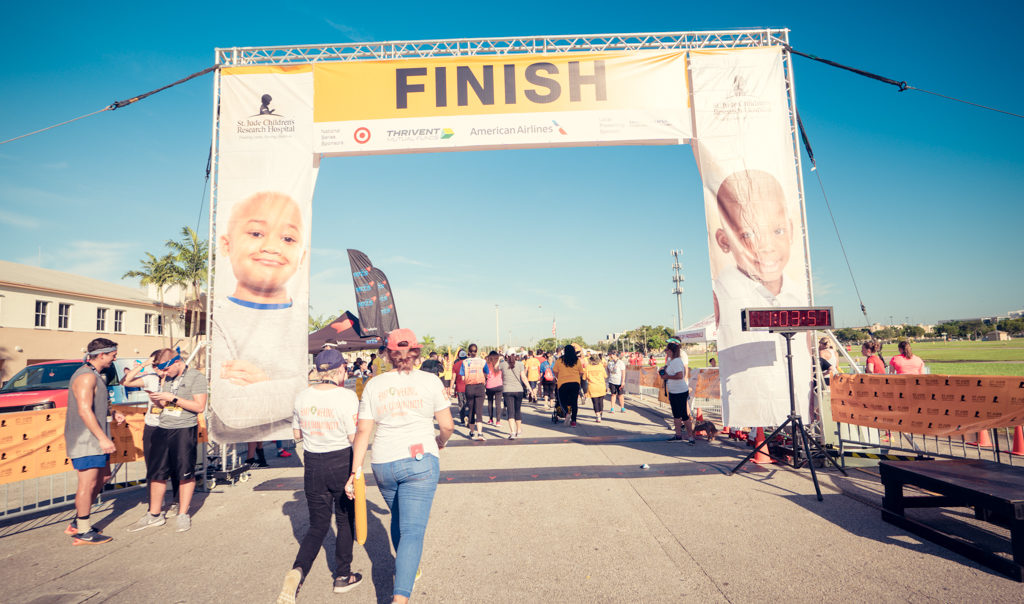 Two people walk towards the finish line at the St. Jude Walk/ Run Against childhood cancer.