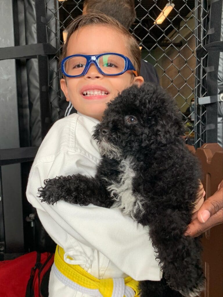 Petland Florida picture of child holding cute Petland puppy at SOFLO Battle of Champions.